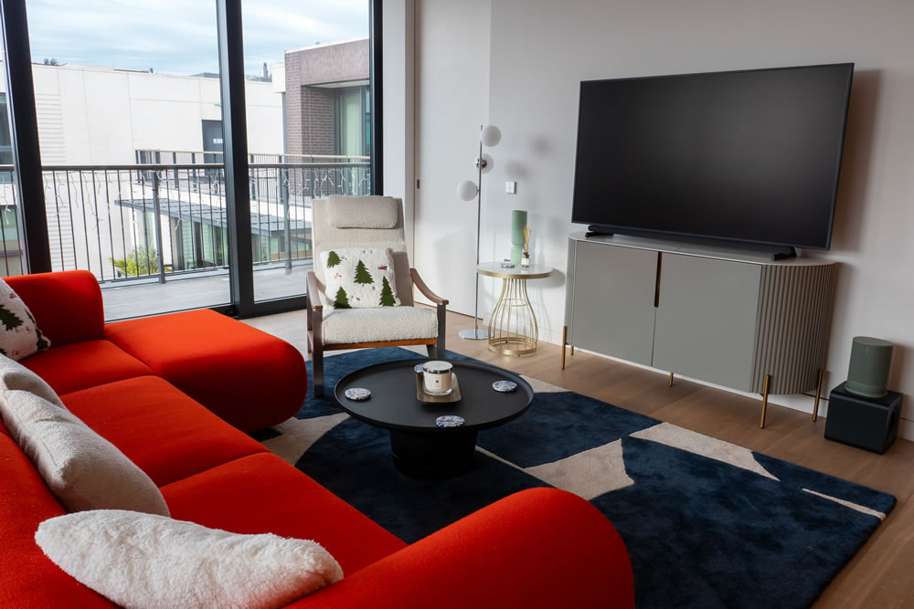 Modern open-plan penthouse interior featuring integrated smart home technology in London