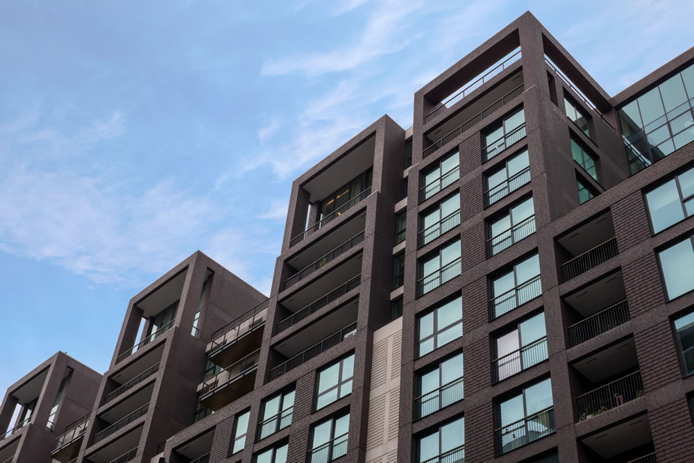Floor-to-ceiling windows with automated external awnings for solar shading in London penthouse