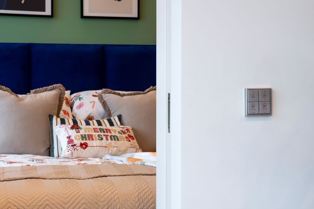 Luxury bedroom featuring automated blackout blinds and smart temperature sensors