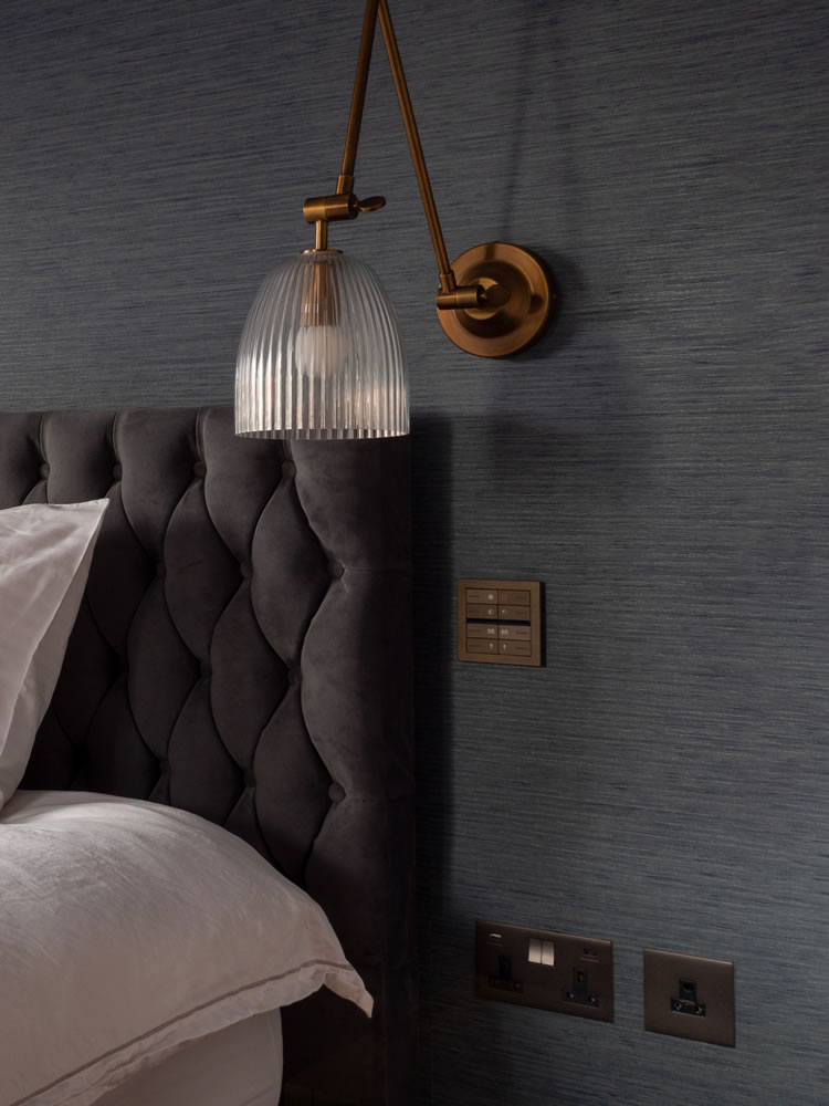 Smart home bedroom at Northmoor Road featuring an Eelectron OL-U brushed bronze KNX control panel and integrated bedside lighting by AVINU