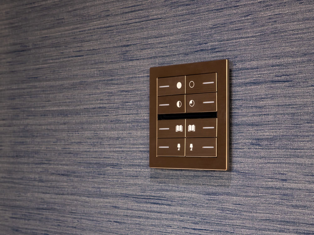 Eelectron OL-U brushed bronze KNX switches with custom Lord of the Rings engraved icons for lighting control