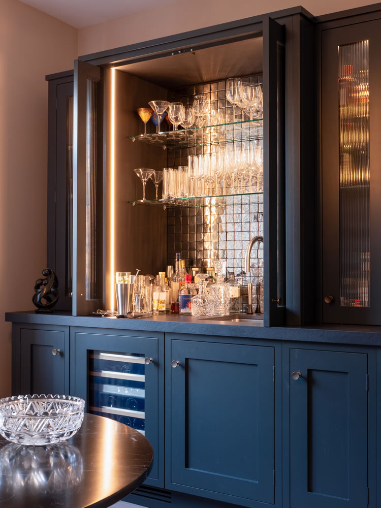 Contemporary home bar area with integrated smart lighting and bespoke cabinetry at Northmoor Road, a Grade II listed smart home project by AVINU